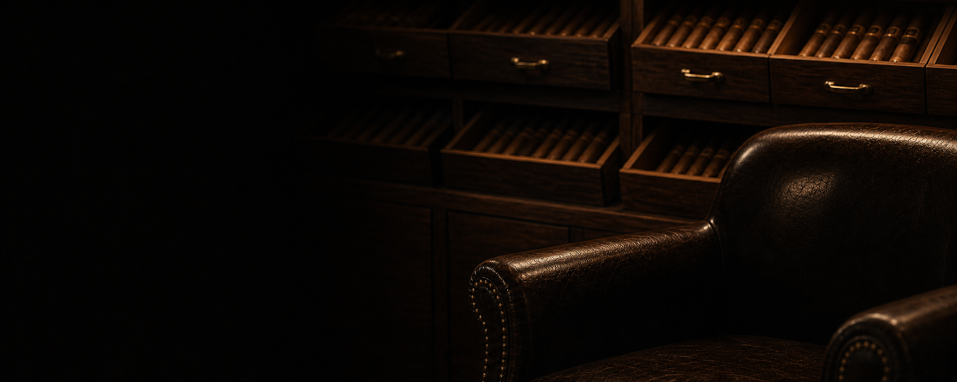 Open cedar humidor drawers and a leather chair in the Lone Wolf lounge